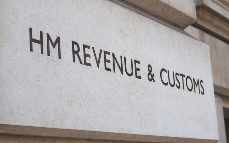 a printing of the HMRC logo on a building, presumably their headquarters where they deal with taxation services