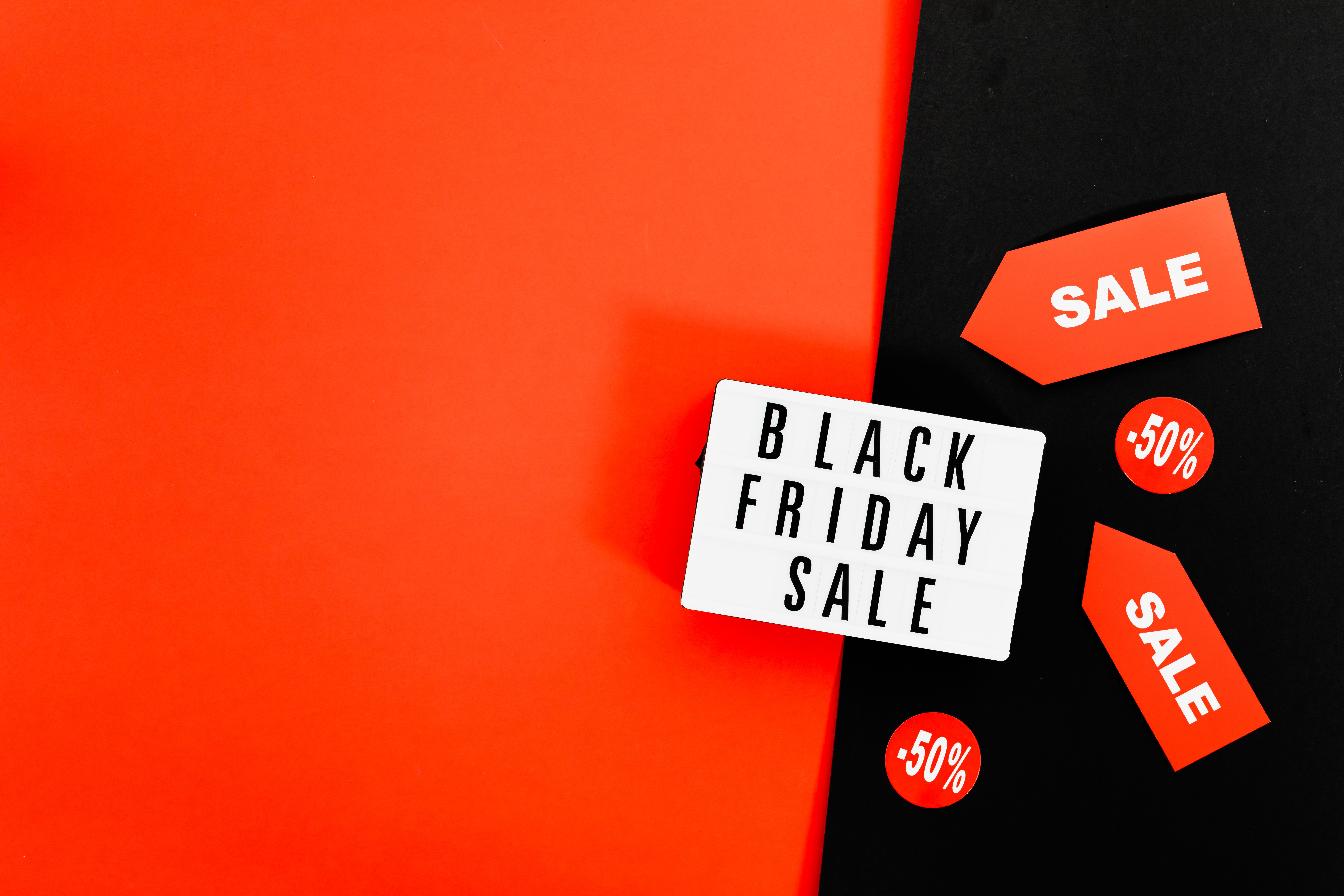 a-red-and-black-image-with-a-sign-on-the-front-advertising-black-friday-and-cyber-monday-sale-offers