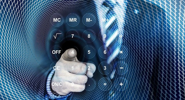 man-using-calculator-for-VAT-Returns-Making-Tax-Digital