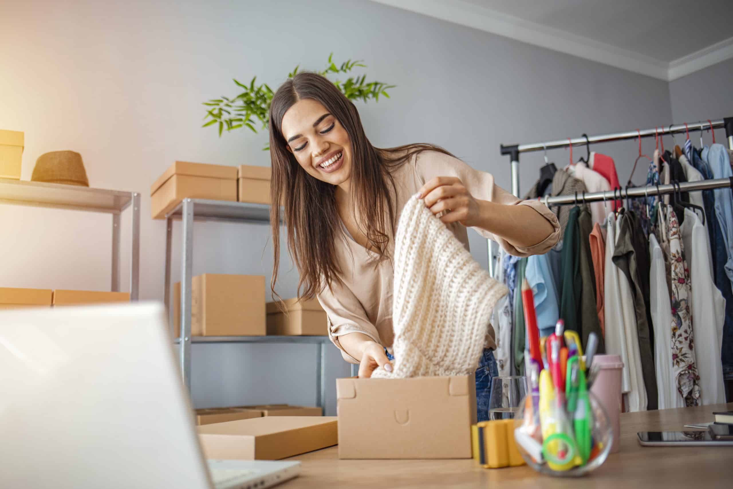 Young woman selling products online and packaging goods for shipping. She is representavie of the SME owners that the Amazon launchpad startup of the year award is trying to celebrate