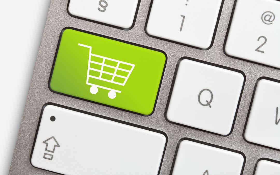 Computer keyboard with green key and shopping cart representing ecommerce for alibaba and worldfirst