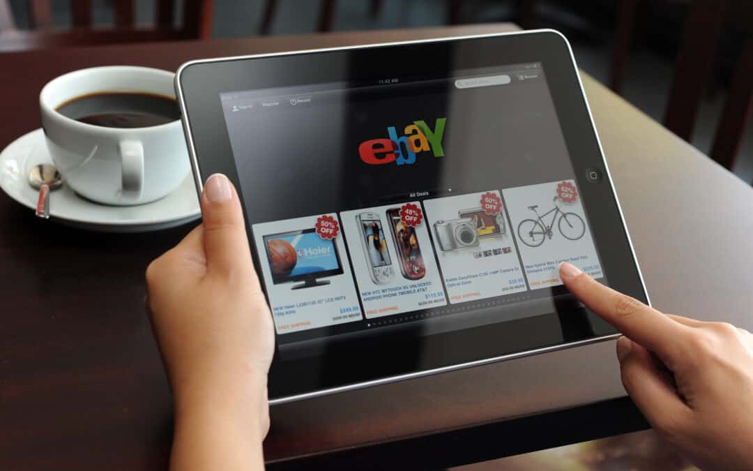 d holding iPad displaying eBay application. eBay seller update autumn 2021 came out in early Septermber