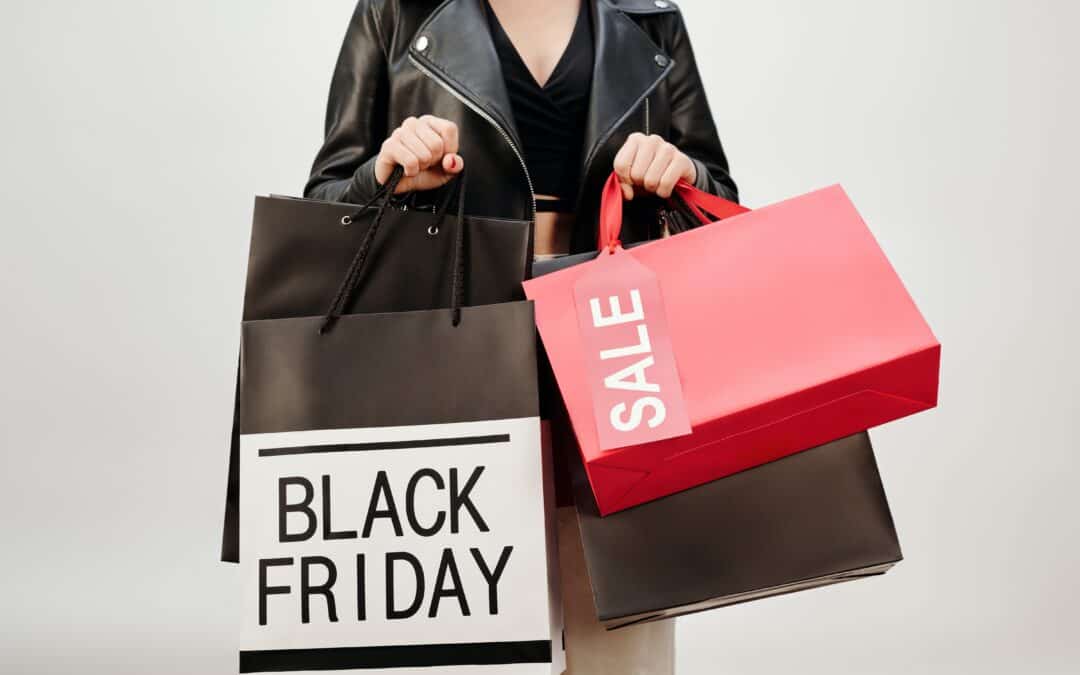 a woman holding black friday shopping bags